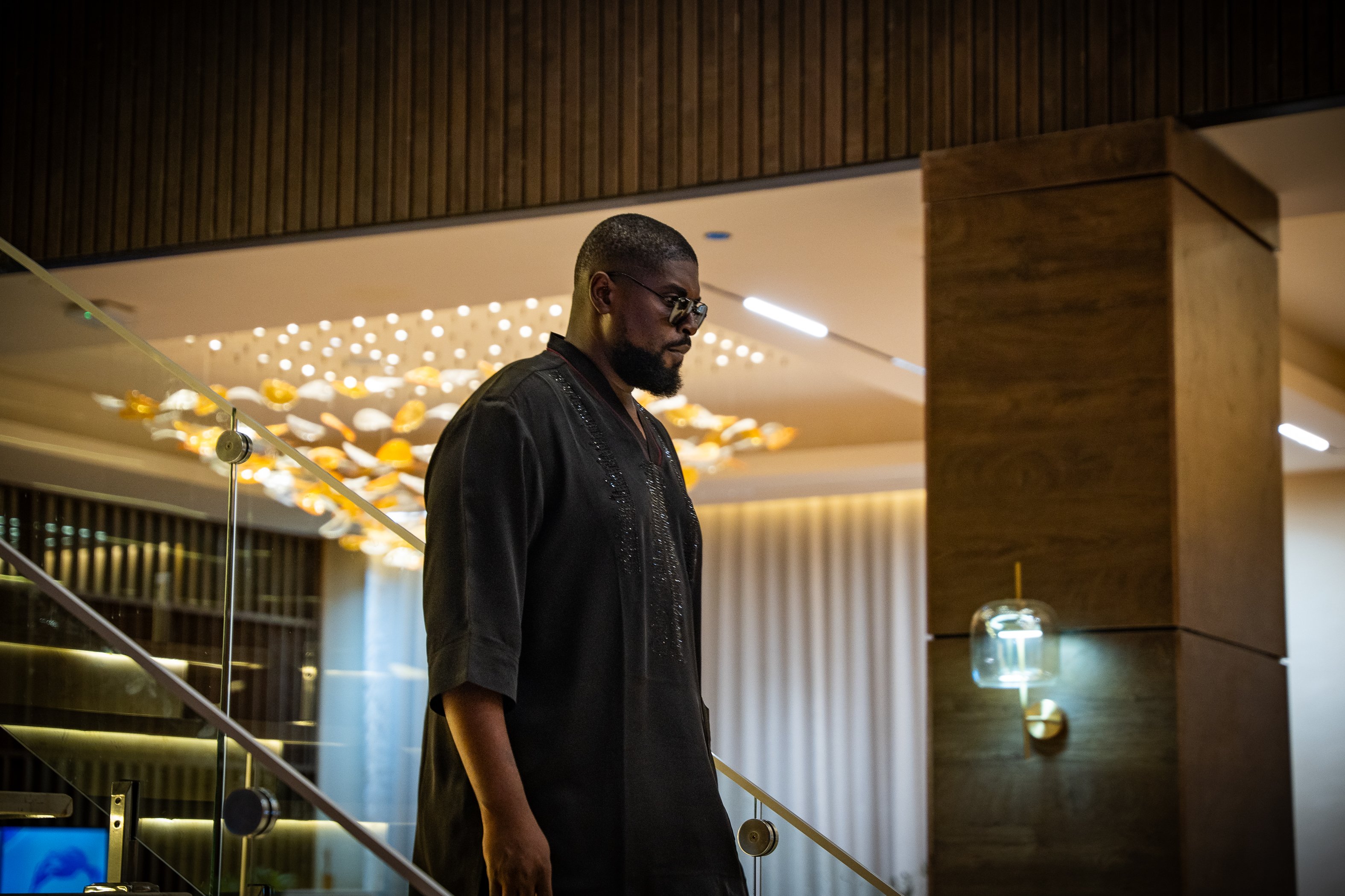 Ebube Enukorah in a warm architectural interior